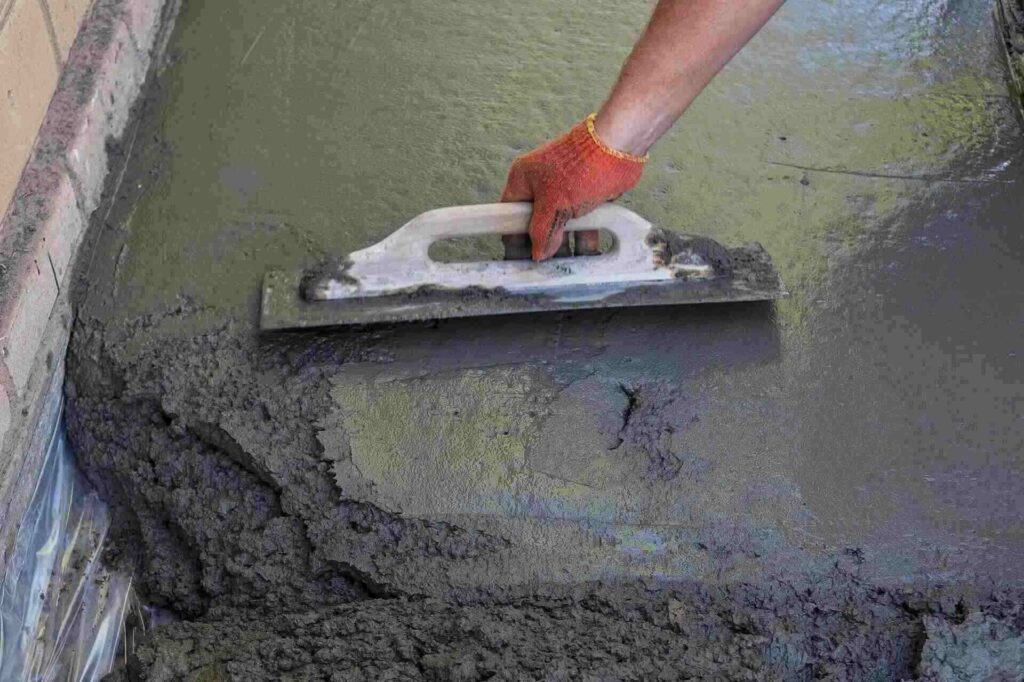 builder smoothing the surface of screed