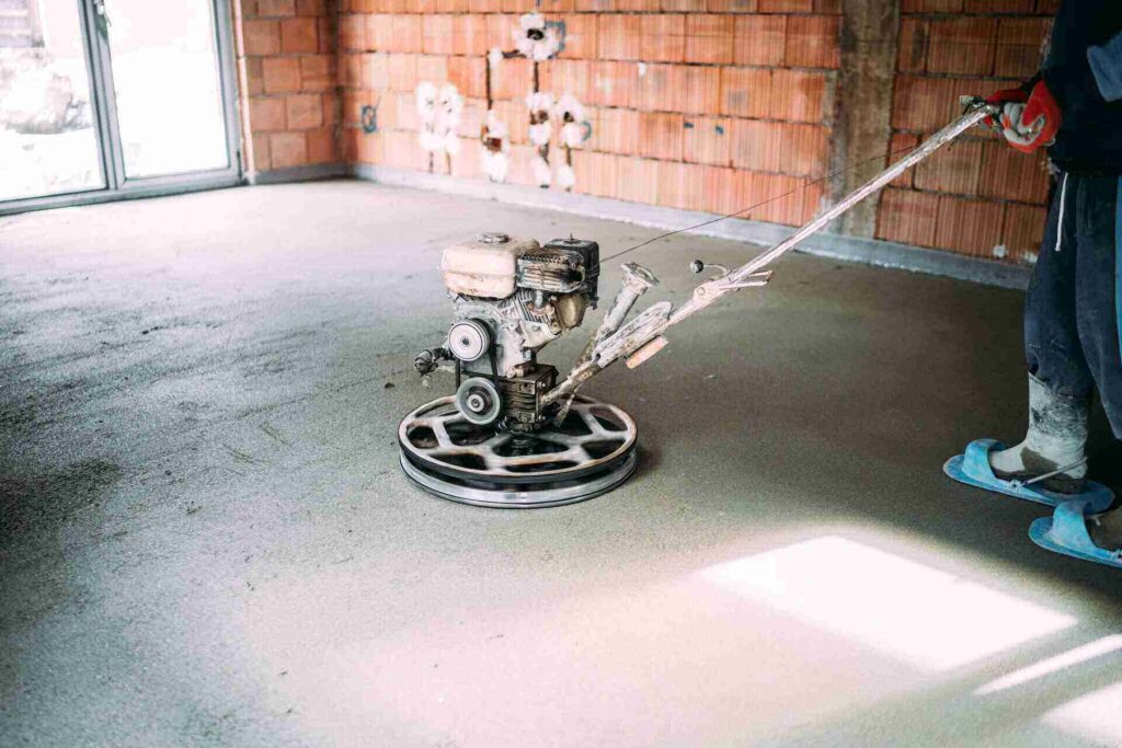 industrial worker finishes concrete screed