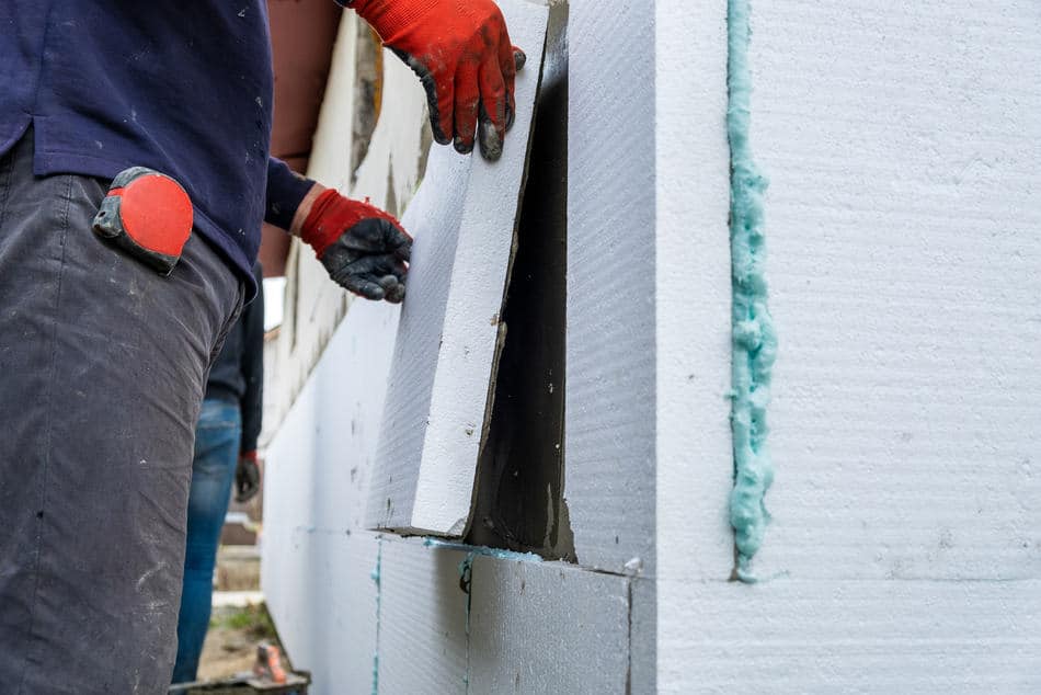 construction worker installing styrofoam insulatio 2023 08 26 09 25 13 utc 1