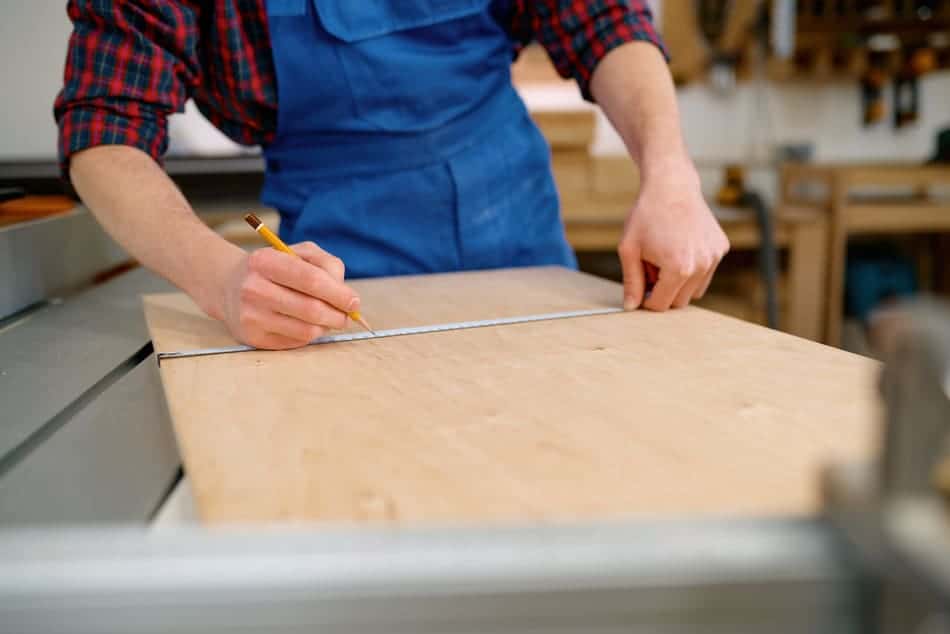 closeup male hand measuring wooden board making fu 2023 11 27 05 06 15 utc 1